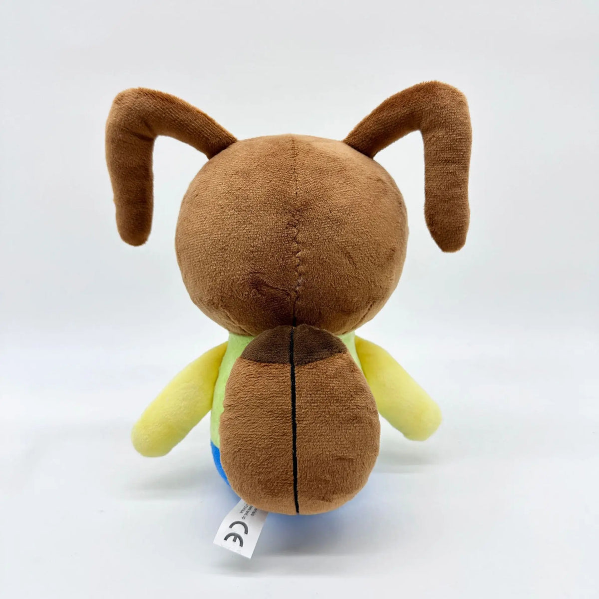 黄色い顔と青い目のユニークなキャラクターぬいぐるみ