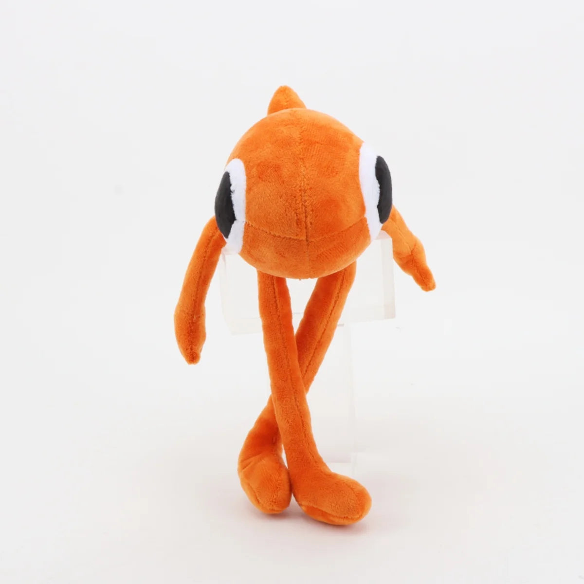 明るいオレンジの 手足が長い ひとつ目ぬいぐるみ