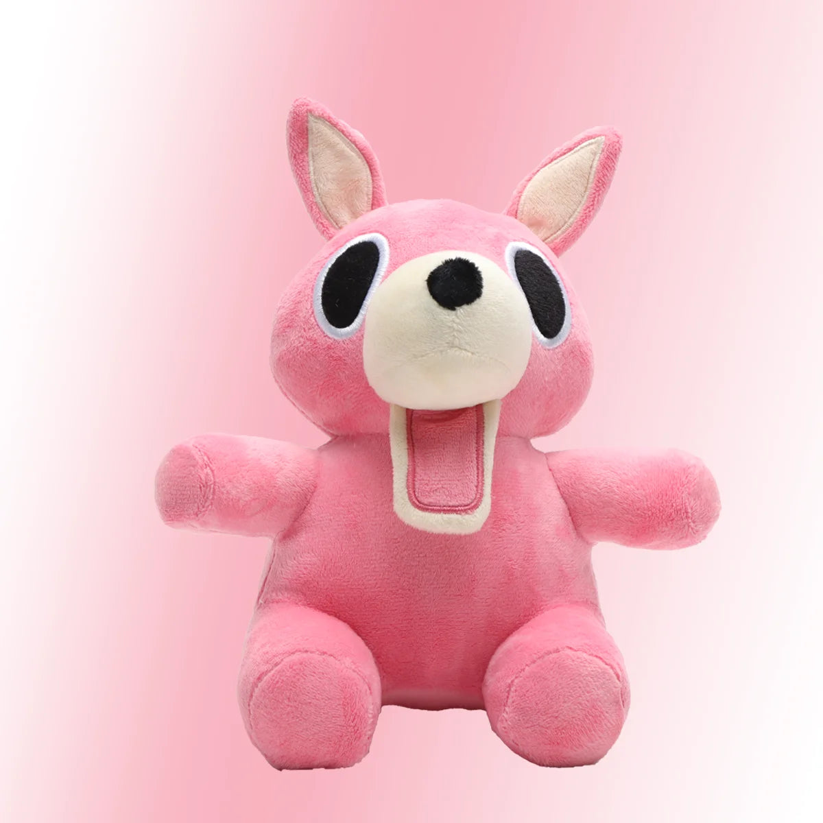 明るいピンクの口を開けたうさぎぬいぐるみ