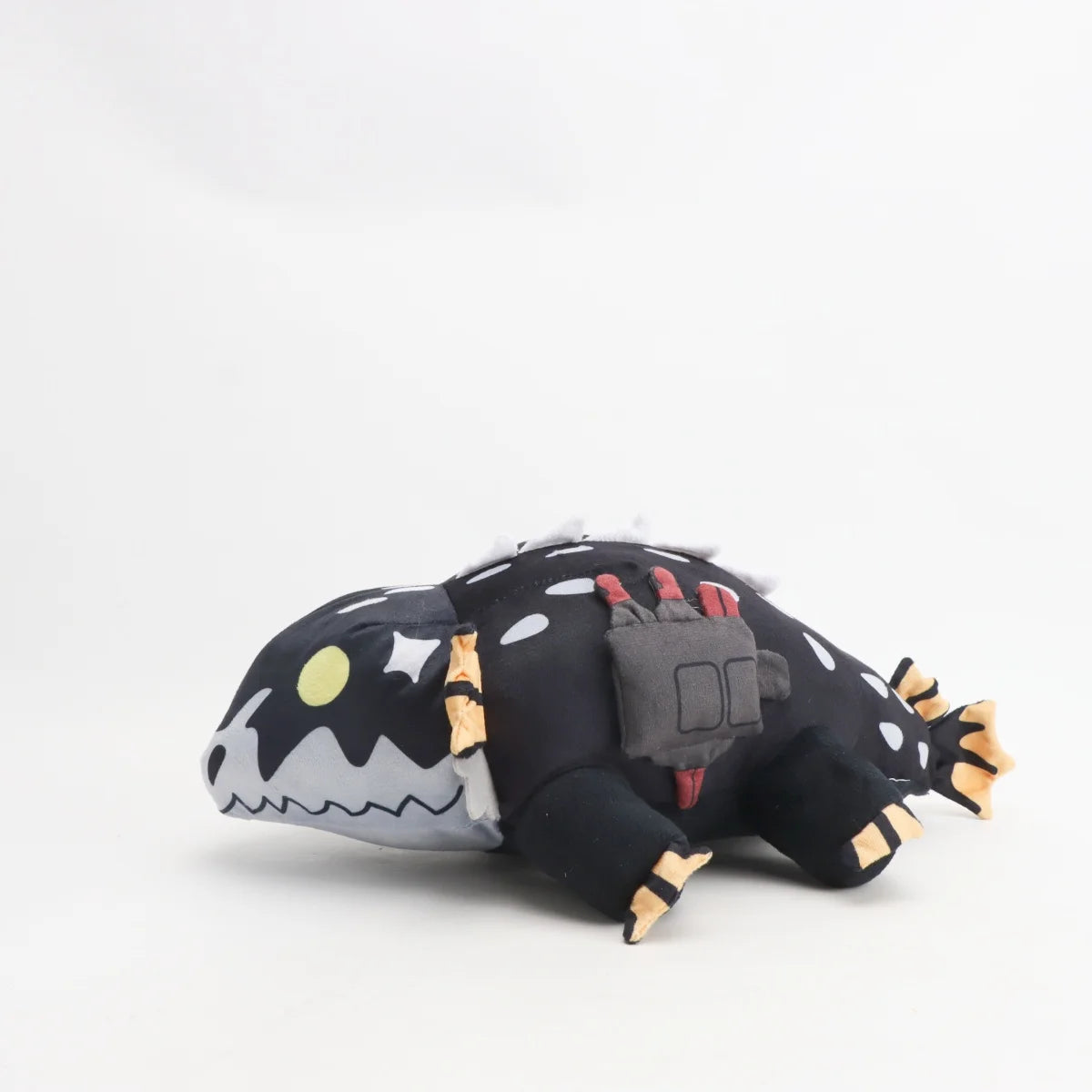 黒い斑点模様のモンスターぬいぐるみ オレンジのヒレと黄色い目