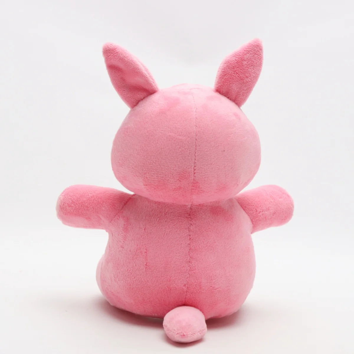 明るいピンクの口を開けたうさぎぬいぐるみ