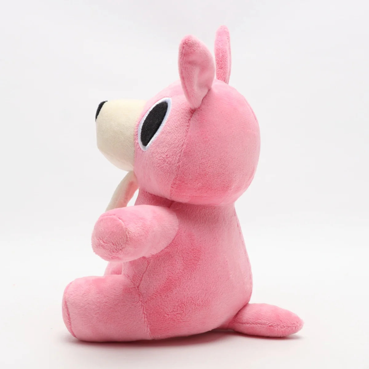 明るいピンクの口を開けたうさぎぬいぐるみ