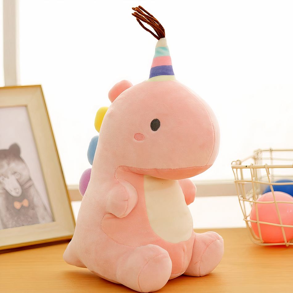 虹色のしっぽが付いた、柔らかくて抱き心地の良い恐竜のぬいぐるみ。23cm / ピンク。The Plush Company