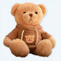 冬の心地よさを追求した、柔らかな茶色のテディベアのぬいぐるみ。The Plush Company