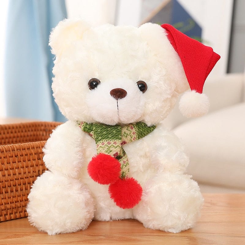 赤と白の帽子をかぶったクリスマスのテディベア