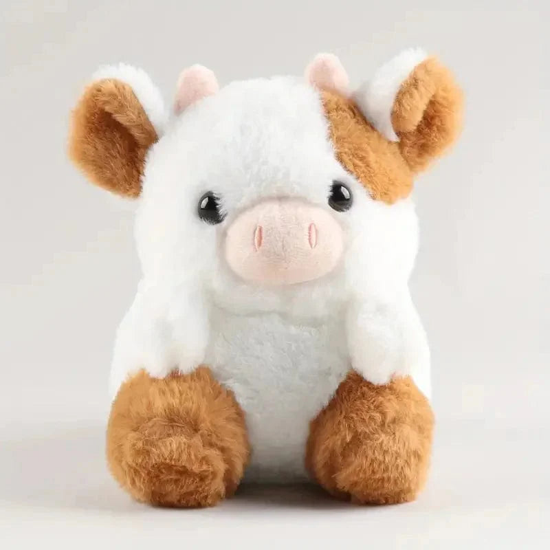 かわいくて柔らかい茶色と白の牛のぬいぐるみ