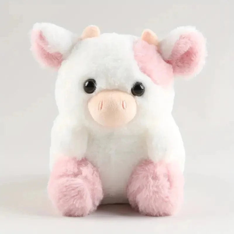 かわいくて柔らかいピンクと白の牛のぬいぐるみ